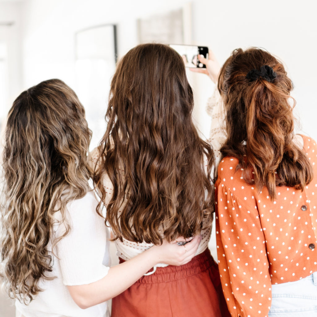 group of three girls taking a selfie for their social media management business